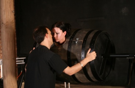 Sexy brunette in a bondage box Goldie giving head to a brutal BDSM handler