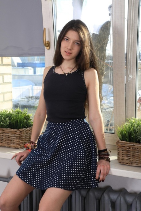 Skinny teen Camille drops her skirt and undies and plays with a sex toy