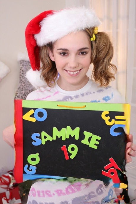Teen with pigtails Sammy Grand shows her naturals & deepthroats a cock at Xmas