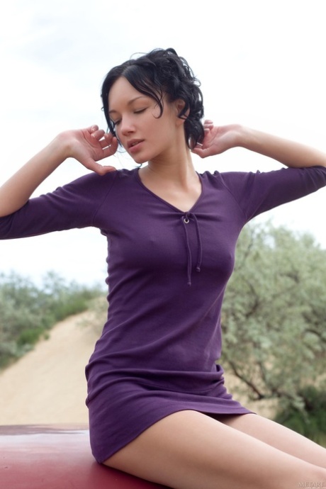 Glamorous brunette Loreen A undressing and posing naked outdoors