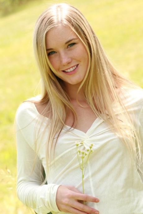 Blonde teen with an adorable pussy Jewel A reveals her tiny tits outdoors
