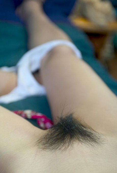Glamorous babe Yuka B undressing and showing her hairy Asian pussy