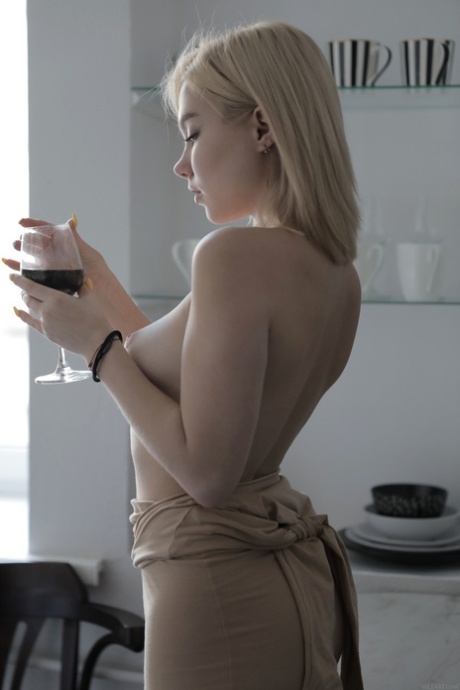 Sweet blonde with a hot body Scarlet undresses and poses on a bed