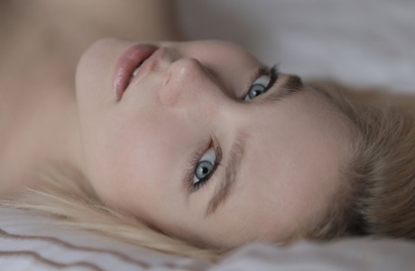 Sweet blonde with a hot body Scarlet undresses and poses on a bed