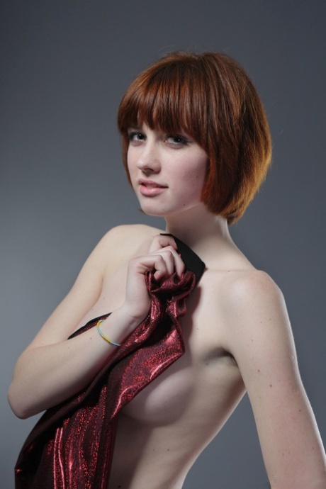 Sexy nude redheaded babe with a cute face Bretta A flaunts her natural tits