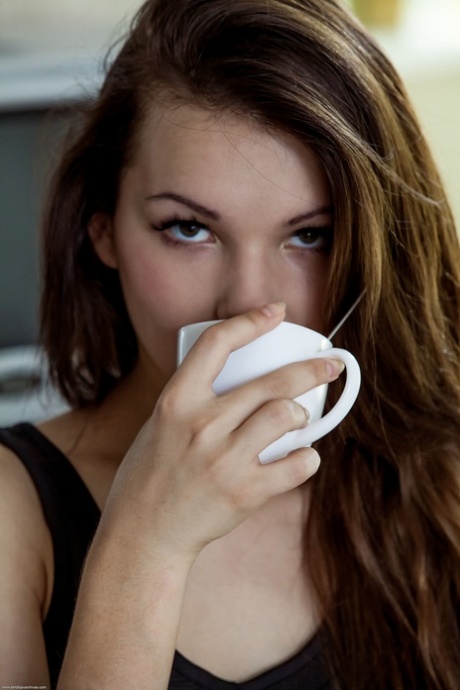 Glamorous teen babe Iva sits on the kitchen floor and shows her yummy pussy