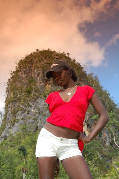 Ebony Maria L removes her shorts & red shirt & teases with her ass outdoors
