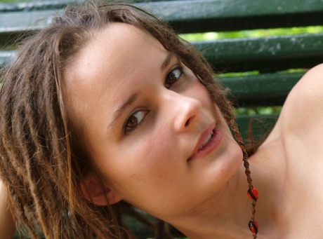 Naked babe Hanka A shows off her small breasts & her trimmed pussy outdoors