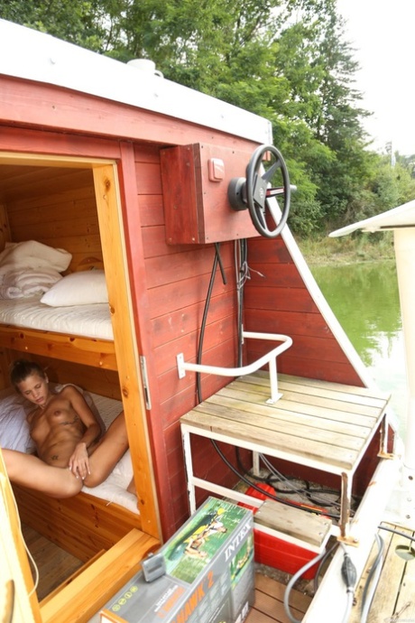 Smiley babe Sara Kay masturbating with a sex toy on her houseboat