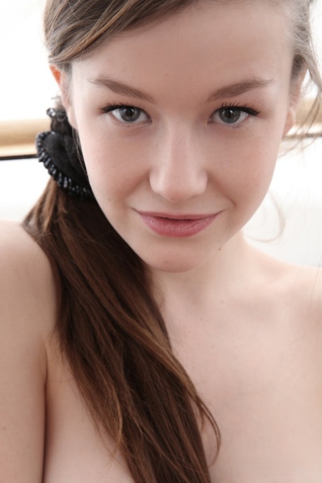 Caucasian babe Emily displays her perfect boobs and bald holes in a solo