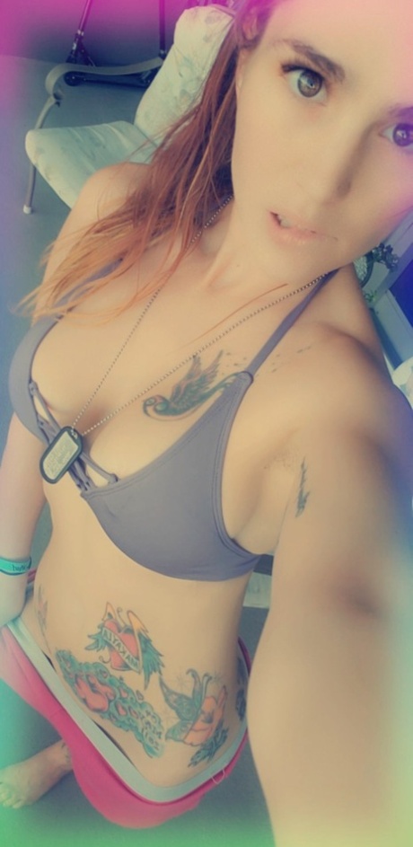Petite babe Kakia Lynn shows her beautiful tattoos wearing sexy lingerie