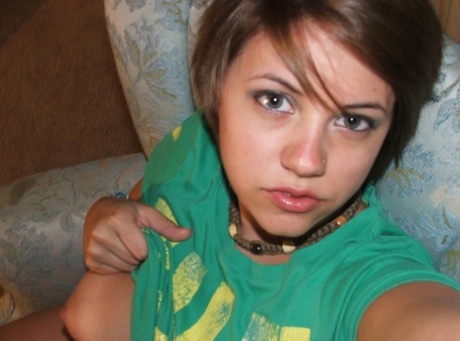 Beautiful short-haired amateur babe shows her big boobs in a solo