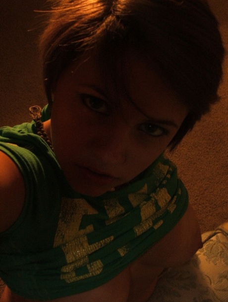 Beautiful short-haired amateur babe shows her big boobs in a solo