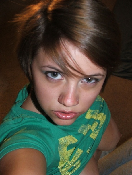 Beautiful short-haired amateur babe shows her big boobs in a solo
