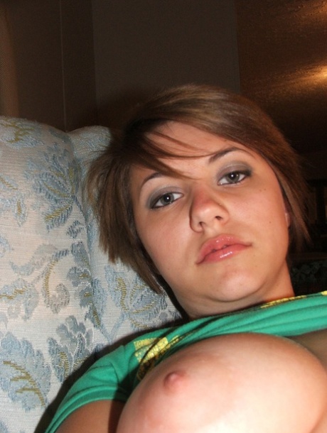 Beautiful short-haired amateur babe shows her big boobs in a solo