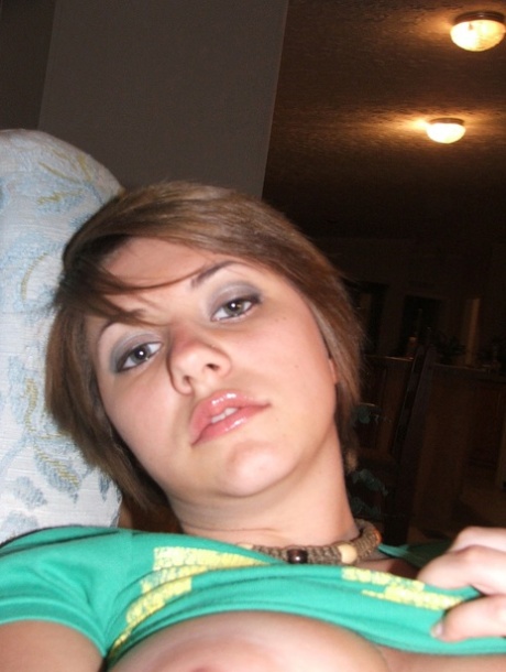 Beautiful short-haired amateur babe shows her big boobs in a solo