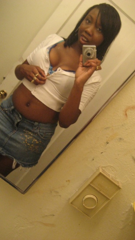 Amateur ebony teen Elisha strips and poses naked in front of the mirror