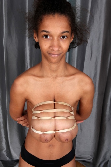 Ebony Addisson shows off her huge breasts and squeezes them in undies