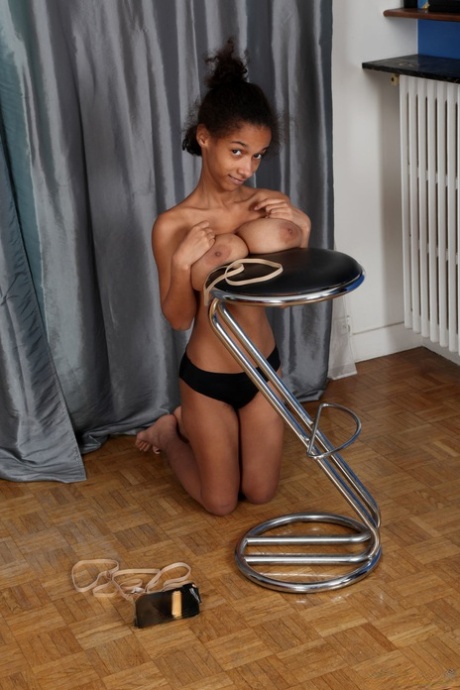 Ebony Addisson shows off her huge breasts and squeezes them in undies