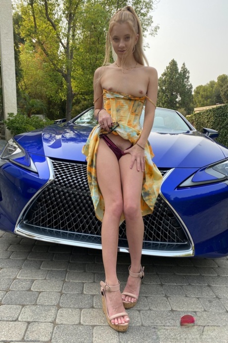 Tiny babe Riley Star shows her big clit and spreads her ass in a convertible