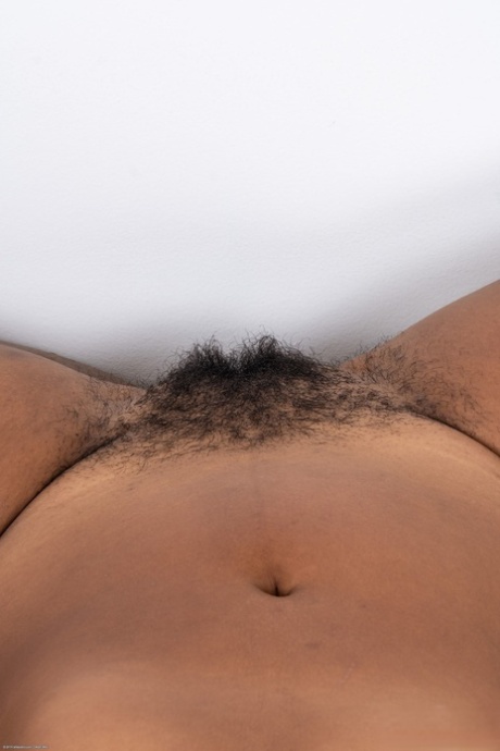 Chubby black babe Daisy shows off her hairy pussy and her great ass