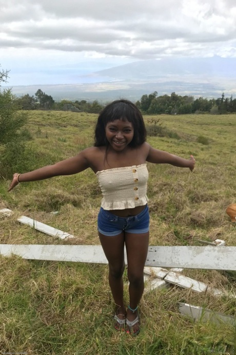 Petite ebony Noemie Bilas exposing her tits, pussy and feet in a solo