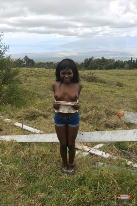 Petite ebony Noemie Bilas exposing her tits, pussy and feet in a solo