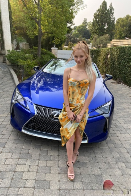 Teen Riley Star spreads her legs in a car to show her twat with a tampon