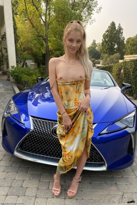 Teen Riley Star spreads her legs in a car to show her twat with a tampon