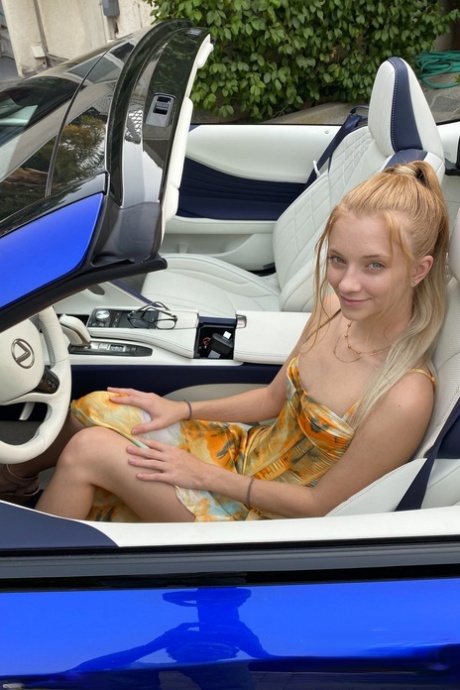 Teen Riley Star spreads her legs in a car to show her twat with a tampon