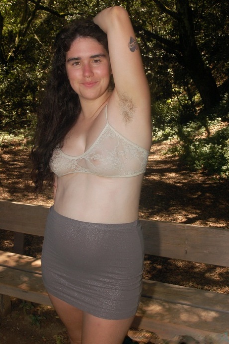 Geeky amateur teen Lucy Haze strips at the park and shows her hairy body