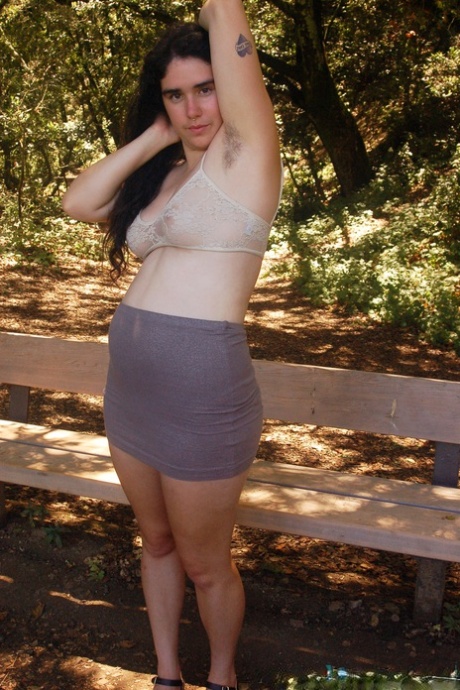 Geeky amateur teen Lucy Haze strips at the park and shows her hairy body