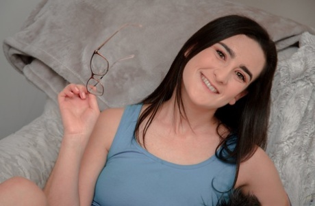 Brunette babe in glasses Lyra Lockhart shows her big tits and jerks off a cock