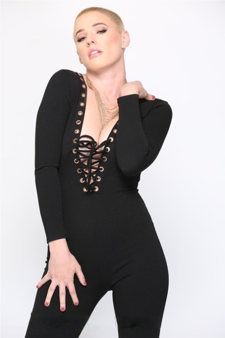 Blonde Riley Nixon poses in her tight black outfit & unveils her big tits