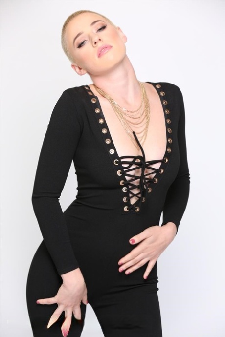 Blonde Riley Nixon poses in her tight black outfit & unveils her big tits