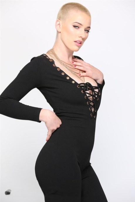 Blonde Riley Nixon poses in her tight black outfit & unveils her big tits