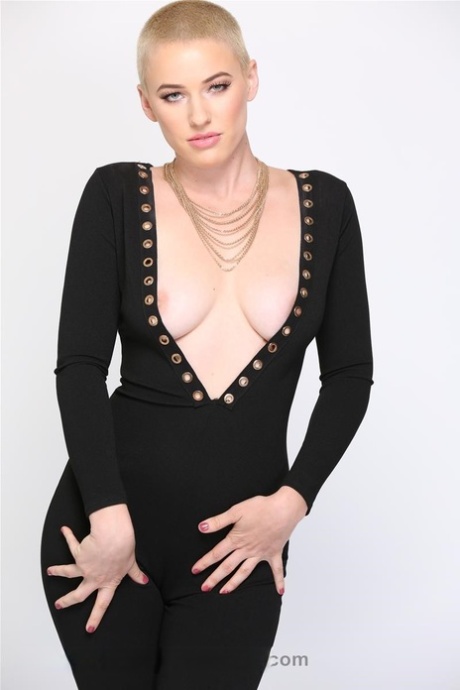 Blonde Riley Nixon poses in her tight black outfit & unveils her big tits