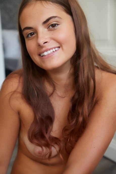 Glamorous brunette teen Minnie strips & shows her big booty with tan lines