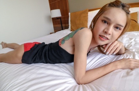 Asian shemale Kitty removes her dress & poses before giving some hot head