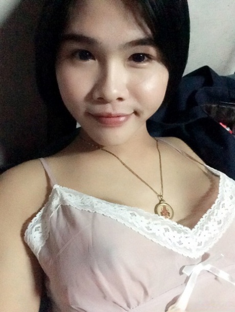 Pretty Asian shemale Gogo posing topless and in hot outfits in sexy selfies