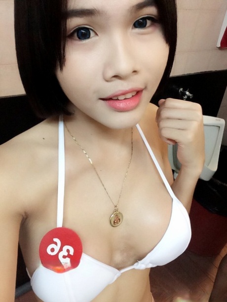 Pretty Asian shemale Gogo posing topless and in hot outfits in sexy selfies