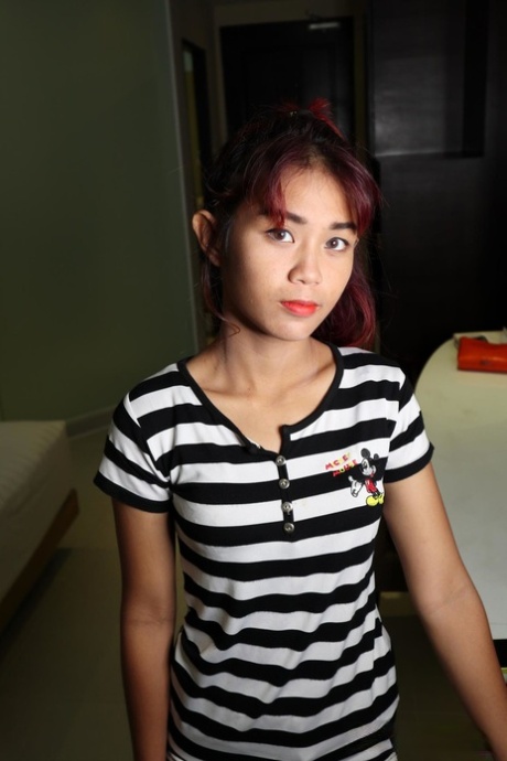 Pretty Asian babe Banjy shows off her petite naked body & her hairy cunt