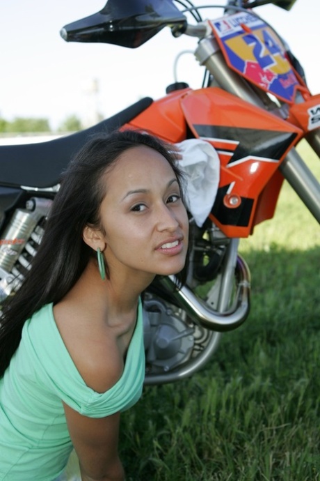 Breathtaking Latina Pamy posing for outdoors for a motorcycle magazine