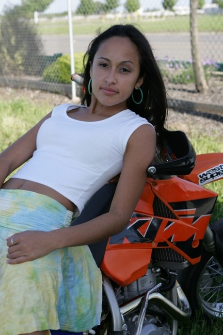 Breathtaking Latina Pamy posing for outdoors for a motorcycle magazine