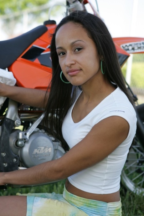 Breathtaking Latina Pamy posing for outdoors for a motorcycle magazine