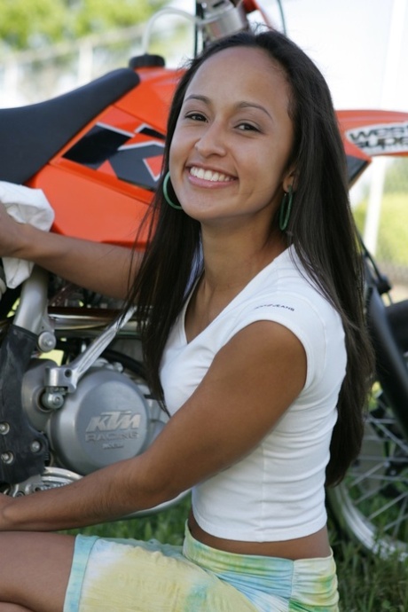 Breathtaking Latina Pamy posing for outdoors for a motorcycle magazine