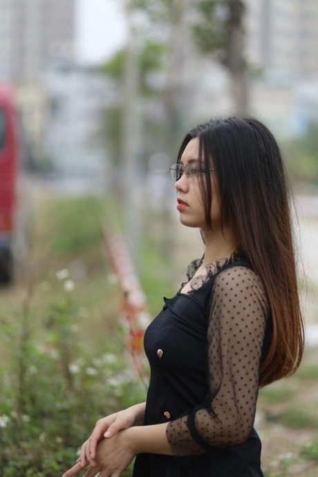 Pretty Asian model Natalia posing in her lovely black outfit outdoors