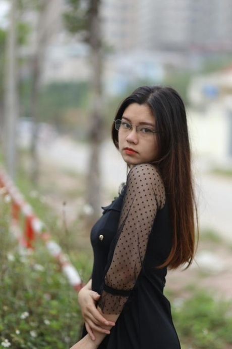 Pretty Asian model Natalia posing in her lovely black outfit outdoors