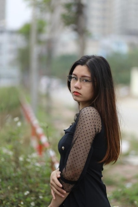 Pretty Asian model Natalia posing in her lovely black outfit outdoors