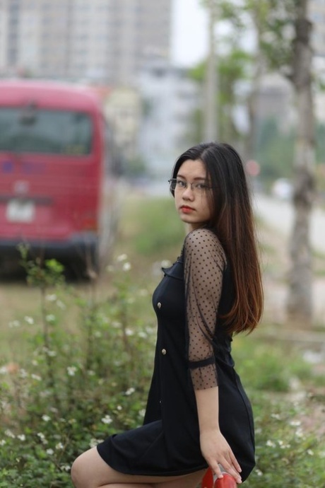 Pretty Asian model Natalia posing in her lovely black outfit outdoors